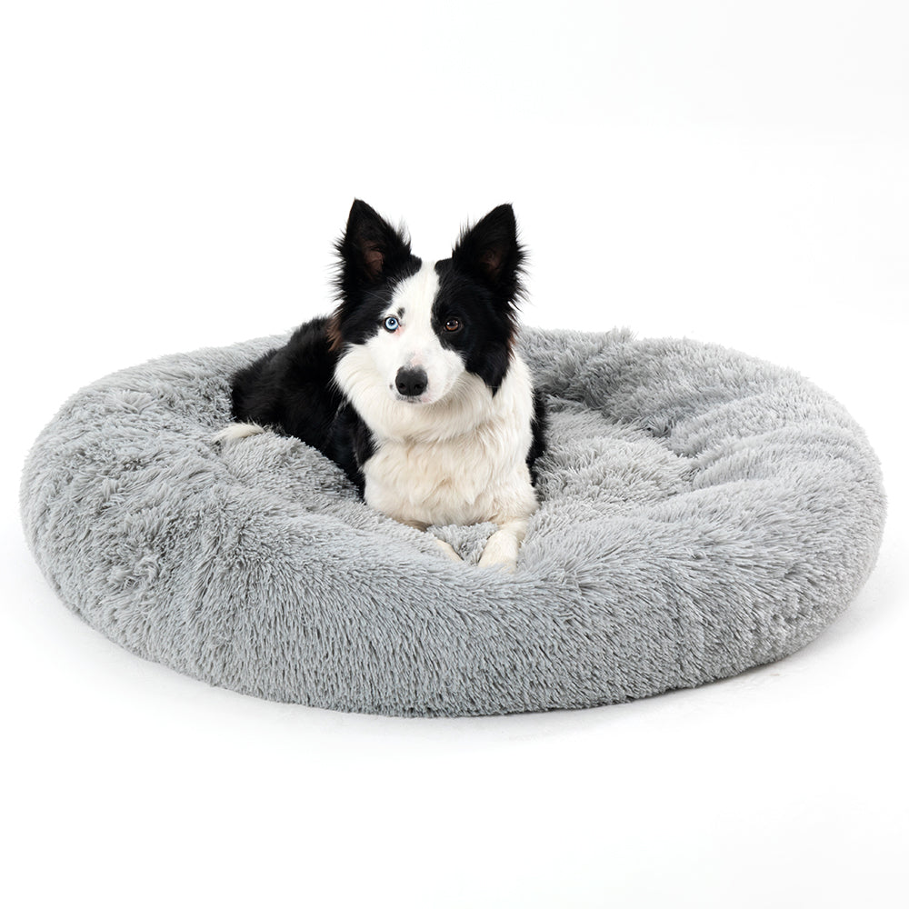 Cat resting inside fluffy donut calming bed